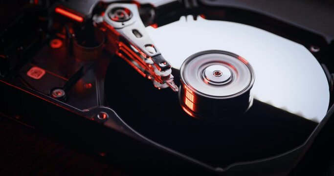 Hard disk drive HDD is working. Spinning up a disk with red light. Computer parts.