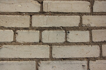 Old dry gray brick wall, painted gray. Background texture.