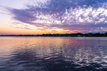 Naklejka premium Pink sunrise with river reflection over St. Sebastian River in Little Hollywood, Mikko, Florida. A typical view of the beautiful nature of Florida