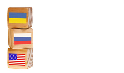 flags of ukraine and russia and united states. leadership concept. country flags on wooden cubes. copy space