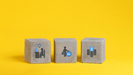 Concrete cubes, blocks on a yellow background. Business strategy and action plan concept. With copy space