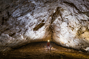 Woman inside the cave standing in underground gallery