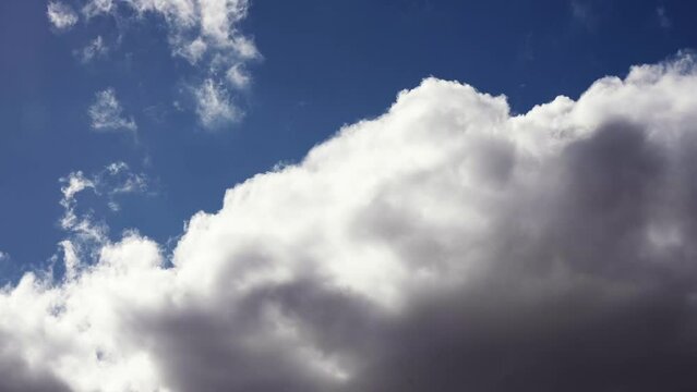 Dynamic cloudscape with huge cumulus clouds boiling and rolling across the sky