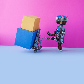 Robot courier and service of delivery and transportation of small parcels, packages. The robot transports a shipment with a cardboard boxes. copy space on blue background