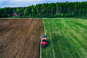 Aerial view of farmer tractor ploughing in field