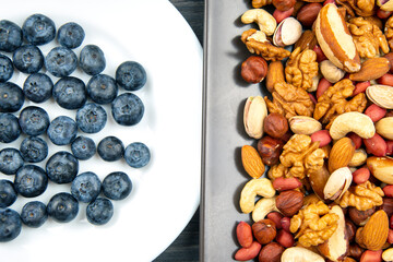 different berries and nuts on a plate. vitamin proteins and healthy foods