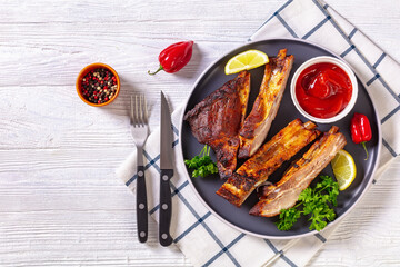 juicy roast pork ribs on plate, top view