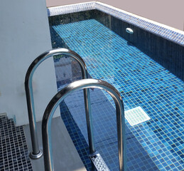 clearwater in the swimming pool is covered with mosaics stair stainless