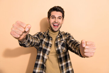 Fototapeta premium Photo of amazed crazy guy hold hands imagine drive fast speed race auto isolated pastel color background