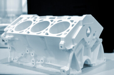 Objects prototype car motor printed on 3d printer from plastic filament close-up. Modern new...