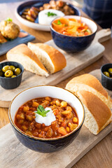 Food served with bread on a table full of food in a restaurant