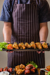 Person holding a plate of Korean fried rice, ready to serve