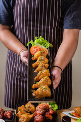 Person holding a plate of Korean fried rice, ready to serve