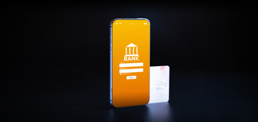 Online banking. Mobile phone with internet online bank app. Credit card on black background. Save...