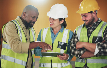 Using modern tech for a modern finish. Shot of a group of builders using a digital tablet while...