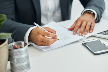 No familiar vibes on my time, Im all new. Shot of unrecognizable businessman doing paperwork at desk.