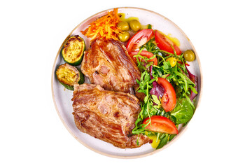 Roasted pork steaks with vegetable salad, isolated on white background.