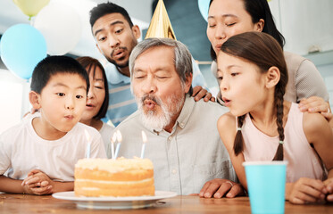 Everything I know I learned after I was 30. Shot of a happy family celebrating a birthday at home.