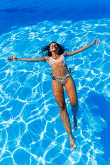 Woman floating on water while on summer vacation