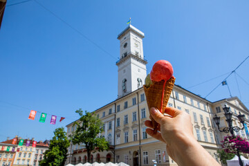 Eating ice cream at hot summer day at Lviv city center