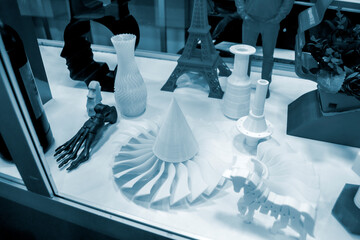 Blue models prototypes printed on 3D printer from plastic close-up. New progressive additive modern...