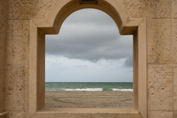 Fototapeta na wymiar Sea and beach view through a window