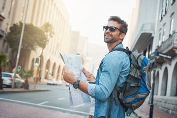 Experience the natural, cultural and man-made wonders of the world. Shot of a young man looking at a map while touring a foreign city. - obrazy, fototapety, plakaty