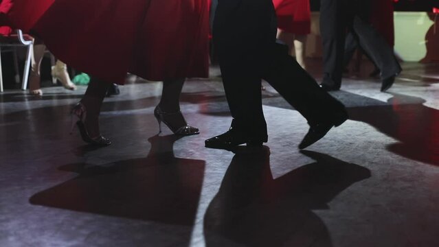 Dancing shoes of young couple, Couples dancing traditional latin argentinian dance milonga in the ballroom, tango salsa bachata kizomba lesson, dance festival, wooden floor, close up view of shoes