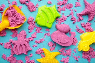 Pink kinetic sand for children, development and play at home with multi-colored sandbox molds