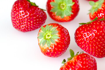 red ripe strawberries on a light background.