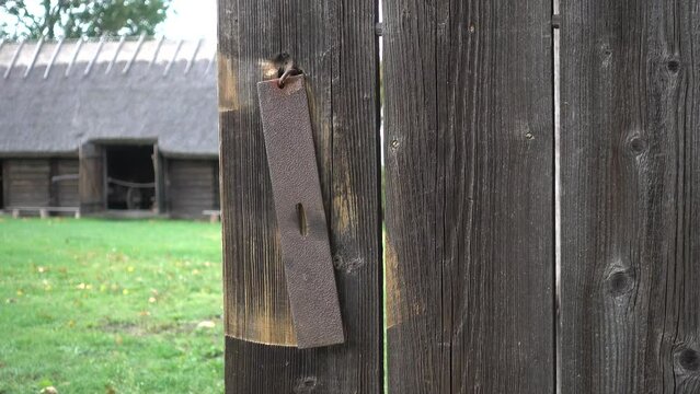 Dangling hook of rustic old wooden door. Estonia.