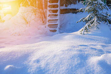 Wooden stairs in the snow. A sunny winter day.