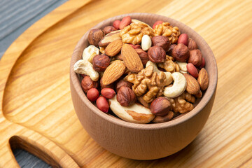 assorted nuts on a kitchen wooden board. vitamin vegetarian food