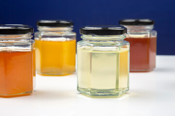 Hexagonal jars with different types and colors of fresh flower honey. vitamin food for health and life