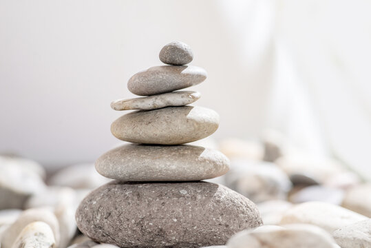 Pyramid of stones on a light background. Concept of sustainable slow life