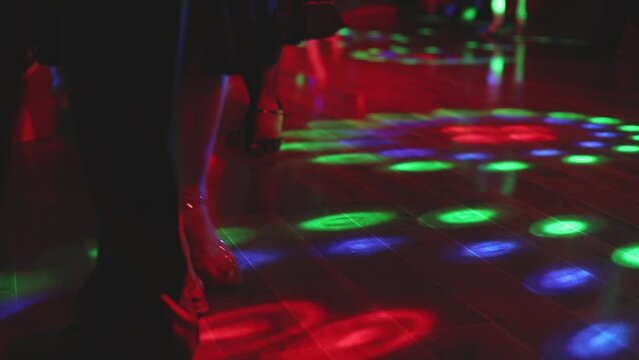 Dancing shoes of young couple, Couples dancing traditional latin argentinian dance milonga in the ballroom, tango salsa bachata kizomba lesson, dance festival, wooden floor, close up view of shoes