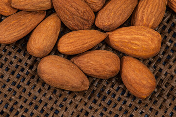 Handful of delicious, healthy almonds on a mesh base