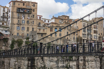 Fototapeta na wymiar View of suspended bridge with old houses on the background, Constantine, Algeria