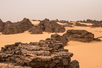 Sand and stones of Hoggar mountains in Sahara desert, Djanet area, Algeria