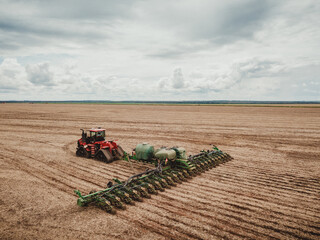 tractor in field of a soybean plantation, harvest