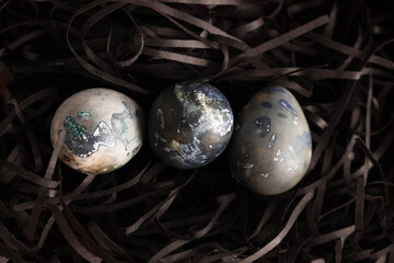 Marble blue Easter eggs ion a black background. Happy Easter holiday, top view, flat lay . Horizontal photo. Hibiscus eggs, naturally colored.