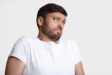 Guy Smelling Unpleasant Stink Frowning Expressing Disgust Over White Background