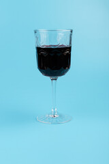 Port wine or fortified red wine  in a glass on blue background. copyspace.