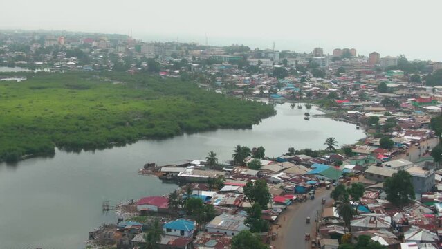 beautiful aerial drone shot of the cityscape of Monrovia, Liberia with the Mesurado River and the atlantic ocean in the background