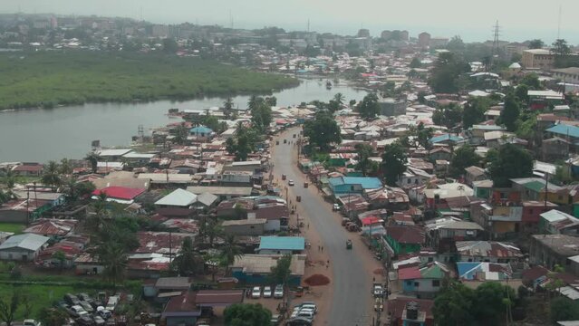 beautiful aerial drone shot of a street in Monrovia, Liberia leading along the Mesurado River