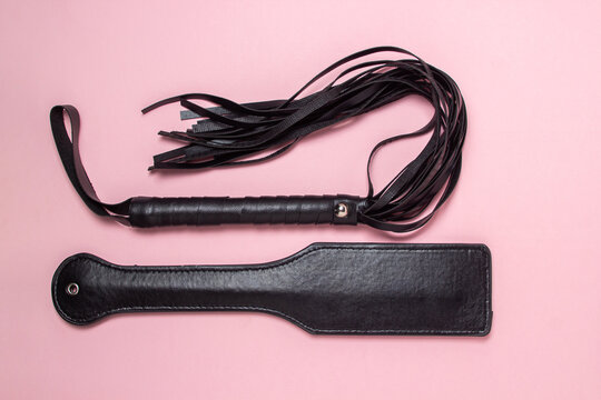 BDSM accessories on a pink background. Toys for adults. Sex accessories