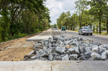 Low angle view of piles of concrete rubble from demolition destroying old road. - Powered by Adobe
