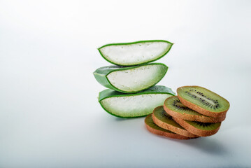 ORGANIC, NATURAL Aloe vera and kiw slice on white background,  with copy space. (Aloe barbadensis Mill, Star cactus, Aloe, Jafferabad or Barbados) a very useful herbal medicine for skin  and hair care
