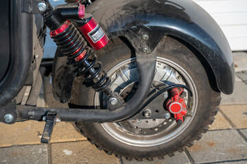 Rear wheel of a motorcycle with brakes and shock absorber.