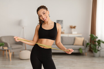Black Lady Measuring Waist With Tape After Weight Loss Indoor